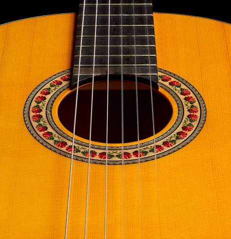 The soundboard of a 2012 Lester DeVoe w/pegs flamenco guitar made of spruce and cypress