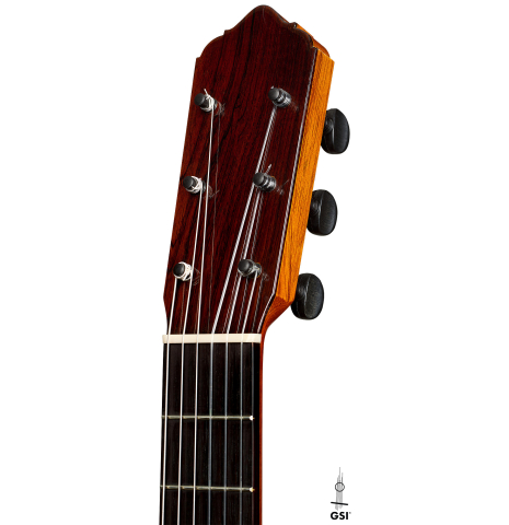 The headstock of a 2012 Lester DeVoe w/pegs flamenco guitar made of spruce and cypress