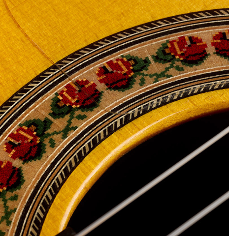 Closeup of the rosette of a 2015 Lester DeVoe "Negra" flamenco guitar with pegs made of spruce and Indian rosewood