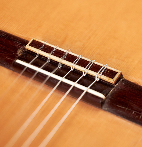 The bridge, saddle and tie block of a 1959 Viuda y Sobrinos de Domingo Esteso made by Conde Hermanos with spruce and Indian rosewood.  
