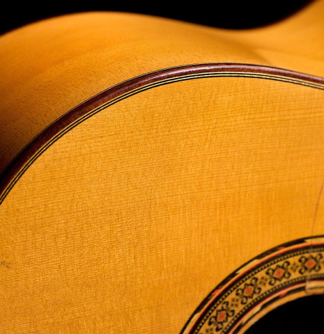 The top and side of a 1985 Gerundino Fernandez flamenco blanca made of spruce and cypress