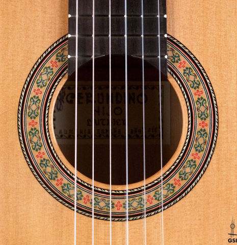 The rosette of a 2018 Gerundino Fernandez Hijo cedar/cypress "Blanca" flamenco guitar with pegs