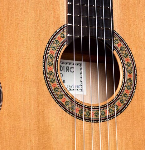 Closeup of the soundboard and rosette of a 2018 Gerundino Fernandez Hijo cedar/cypress "Blanca" flamenco guitar with pegs