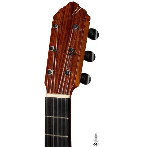 The headstock of a 1999 Gerundino Fernandez w/pegs flamenco guitar made of spruce and cypress