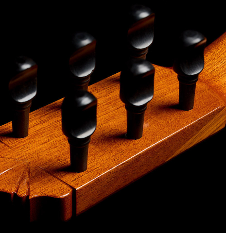 The traditional wooden tuning pegs of a 1999 Gerundino Fernandez w/pegs flamenco guitar made of spruce and cypress