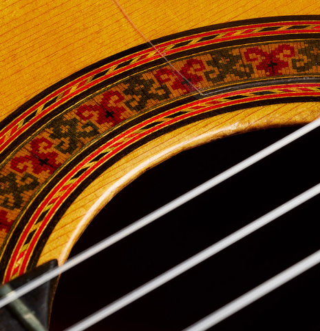 Close-up of the rosette of a 1961 Arcangel Fernandez flamenco blanca guitar with pegs made of spruce and cypress.