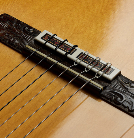 The bridge, tie-block and saddle of a 1971 Jeronimo Pena Fernandez "Flamenco Negra" w/pegs made of spruce and Honduran rosewood