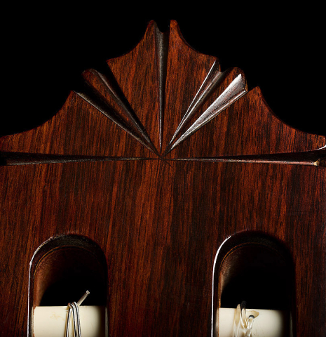 The carved headstock of a 1975 Gerundino Fernandez "Negra" flamenco guitar made of spruce and Indian rosewood