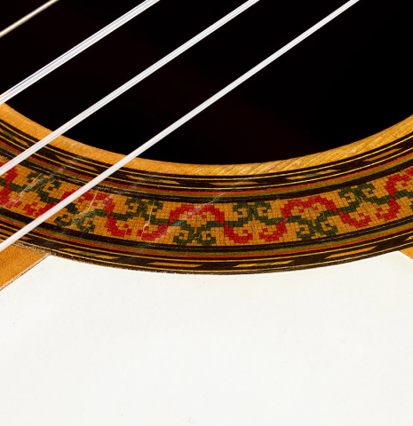 The soundhole, rosette and golpeador of a 1970 Arcangel Fernandez flamenco guitar made of spruce and cypress