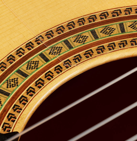 Detailed close-up of the rosette of a 2024 Dario Garcia flamenco guitar made of spruce and cypress