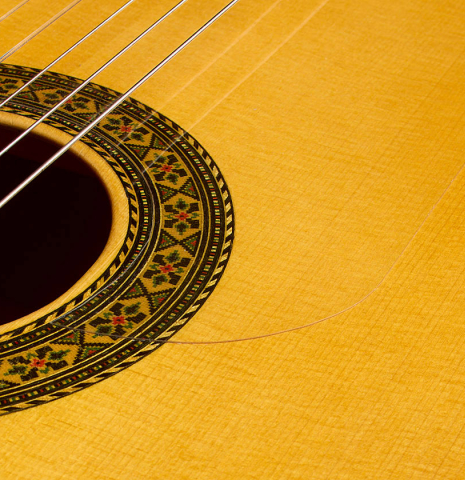 The soundboard and rosette of a 1998 Gerundino Fernandez flamenco guitar made of spruce and cypress