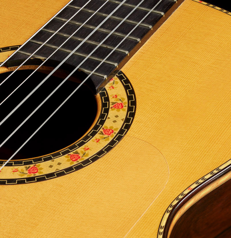 The soundboard and rosette of a 2006 Conde Hermanos "Felipe V" flamenco negra guitar made of spruce and CSA rosewood
