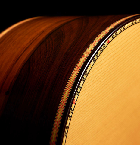 The top binding and purflings of a 2006 Conde Hermanos "Felipe V" flamenco negra guitar made of spruce and CSA rosewood