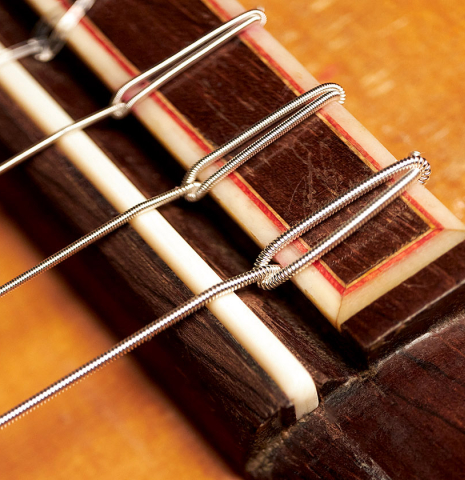 The bridge, tie-block and saddle of a 1966 Conde Hermanos (Sobrinos de Esteso) ex Alberto Velez flamenco guitar made with spruce and cypress