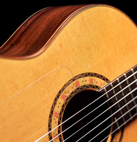 The soundboard and rosette of a 2000 Conde Hermanos "AF 25/R" flamenco guitar made with spruce and CSA rosewood.