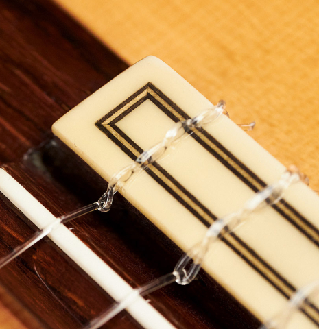 The tie block of a 2000 Conde Hermanos "AF 25/R" flamenco guitar made with spruce and CSA rosewood.
