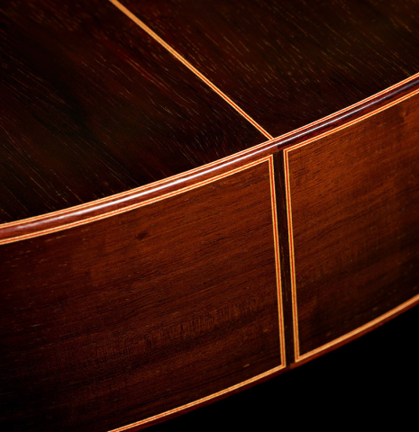 The sides at the foot of a 2008 Conde Hermanos "AF 25/R" flamenco guitar made with spruce and CSA rosewood.
