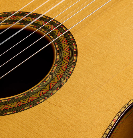 The soundboard and rosette detail of a 2006 Conde Hermanos "Felipe V" flamenco guitar made of spruce and cypress