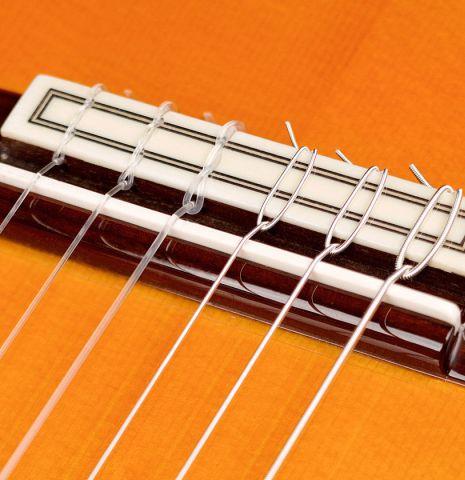 The bridge and saddle of a 2010 Felipe Conde &quot;FC 27&quot; flamenco guitar made with spruce and Indian rosewood