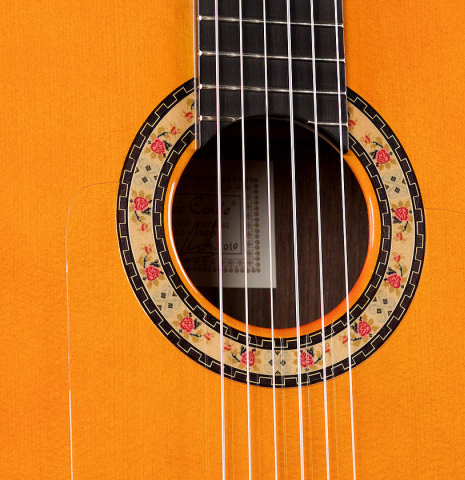 The soundboard and rosette of a 2010 Felipe Conde &quot;FC 27&quot; flamenco guitar made with spruce and Indian rosewood