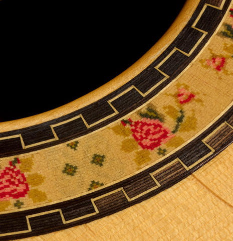 The rosette and tap plate of a 2001 Conde Hermanos "AF 25/R" flamenco guitar made of spruce and CSA rosewood