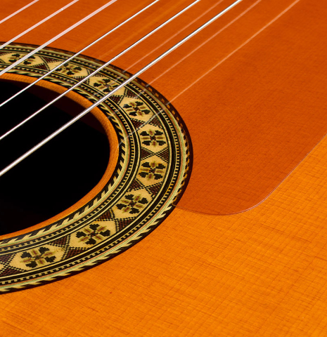 The soundboard and tap-plate of a 1987 Conde Hermanos "Negra" flamenco guitar made of spruce and Indian rosewood