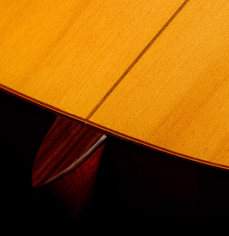 The heel, back binding and purfling of a 1992 Conde Hermanos w/pegs flamenco guitar made of spruce and cypress