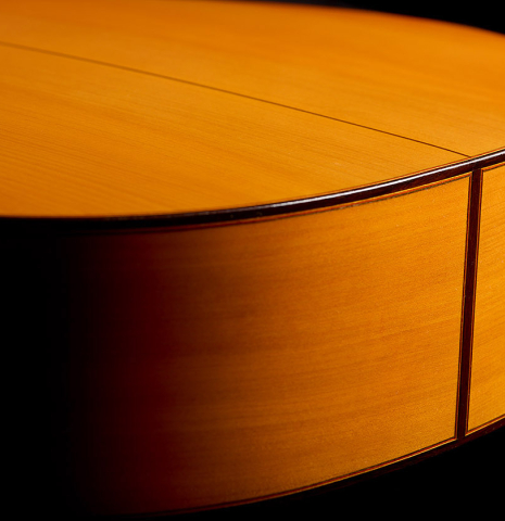 The back and sides at the foot of a 1992 Conde Hermanos w/pegs flamenco guitar made of spruce and cypress