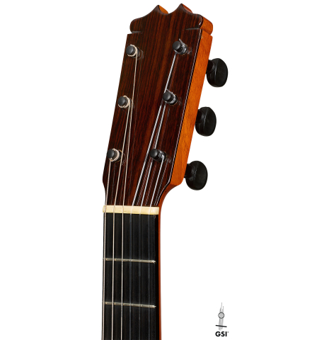 The headstock of a 1992 Conde Hermanos w/pegs flamenco guitar made of spruce and cypress
