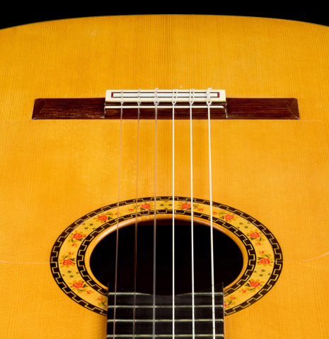 The  soundboard and soundhole of a 1999 Conde Hermanos "Concert Blanca" made of spruce and cypress