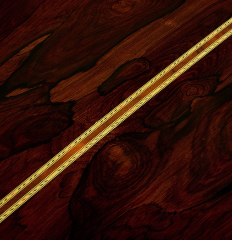 The back center seam of a 2001 Conde Hermanos "Felipe V" flamenco negra guitar made of cedar and CSA rosewood