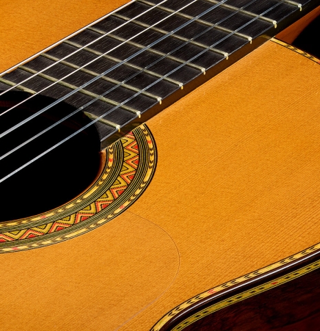 The soundboard and rosette of a 2001 Conde Hermanos "Felipe V" flamenco negra guitar made of cedar and CSA rosewood