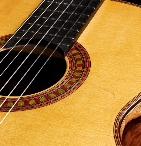 The soundboard of a 2024 Wolfgang Jellinghaus "Flamenca Negra" flamenco guitar with spruce and Granadillo.