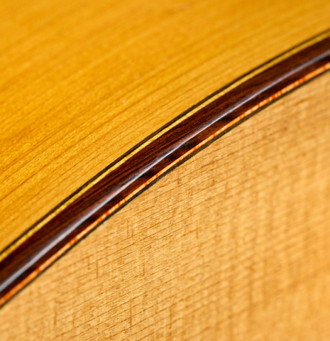 The top binding and purfling of a 1961 Marcelino Lopez "Blanca" flamenco guitar made of spruce and cypress