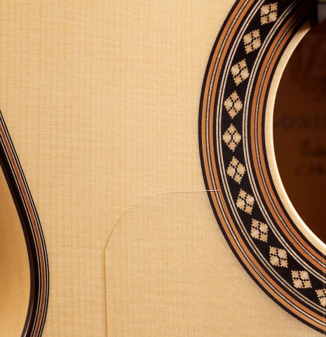 The soundboard and rosette of Loriente &quot;Carmen&quot; flamenco guitar made with spruce top and cypress back and sides