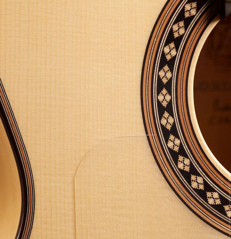 The soundboard and rosette of Loriente "Carmen" flamenco guitar made with spruce top and cypress back and sides