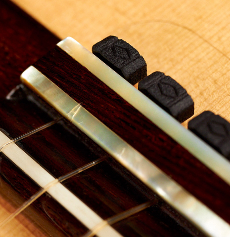 The bridge, saddle and tieblocks of a 1990 Antonio Marin Montero flamenco guitar made of spruce and cypress