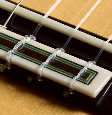 The bridge, tie-block and saddle of a 2026 Teodoro Perez "Flamenco Blanca" guitar made of spruce and cypress