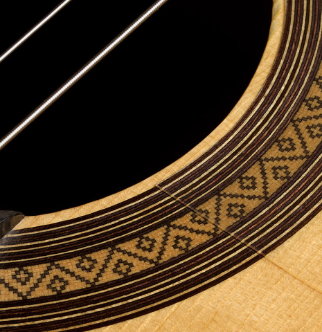 The top and rosette of a 2014 Jose Marin Plazuelo "Negra" flamenco guitar made of spruce and Indian rosewood