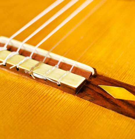 The bridge and saddle of a c. 1912 Manuel Ramirez flamenco guitar made with spruce and cypress
