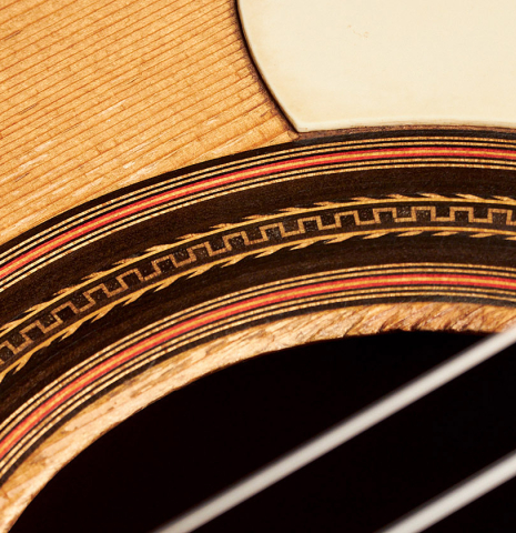 The soundboard and rosette of a 1916 Viuda de Manuel Ramirez flamenco guitar made with spruce and cypress and pegs