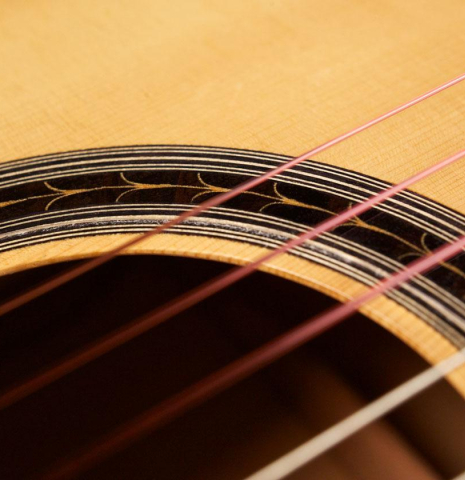 The close-up of a rosette of a 2003 Antonio Raya Pardo flamenco guitar made with spruce top and cypress back and sides