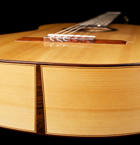 The side of a 2003 Antonio Raya Pardo flamenco guitar made with spruce and cypress
