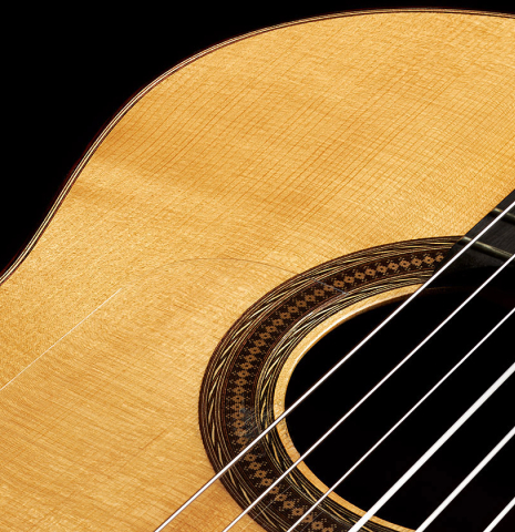 The soundboard and rosette of a 2003 Antonio Raya Pardo "Negra" flamenco guitar made of spruce and CSA rosewood
