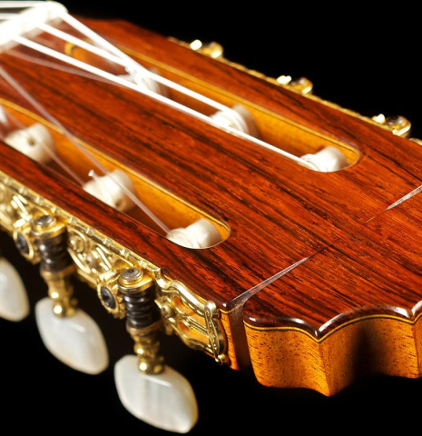 The headstock and tuning machines of a 1976 Manuel Reyes flamenco blanca guitar made of spruce and cypress