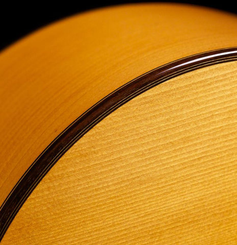 The top binding and purfling of a 1976 Manuel Reyes flamenco blanca guitar made of spruce and cypress