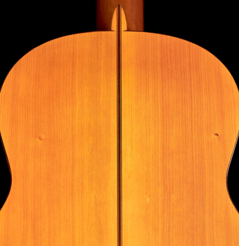 The back of a 1974 Manuel Reyes flamenco guitar made of spruce and cypress with traditional pegs