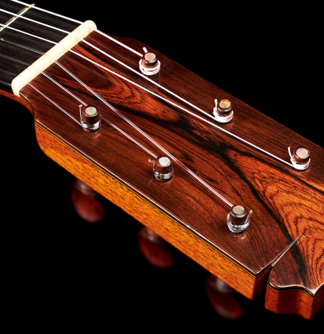 The headstock of a 1974 Manuel Reyes flamenco guitar made of spruce and cypress with traditional pegs