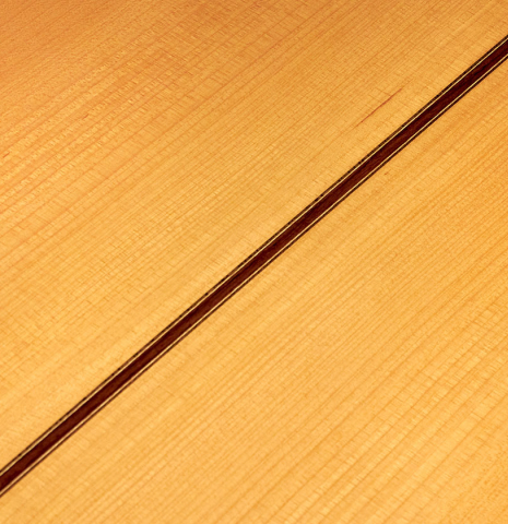 A close up of the back of a 2007 Manuel Reyes flamenco guitar made of spruce and cypress