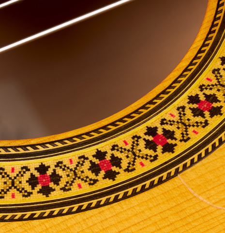 Closeup detail of the rosette of a 1997 Manuel Reyes flamenco guitar made of spruce and cypress